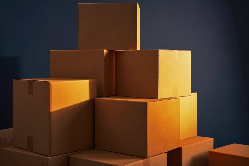 Stacked kraft corrugated cartons in warm light